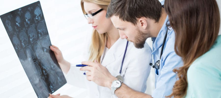 doctors studying MRI report